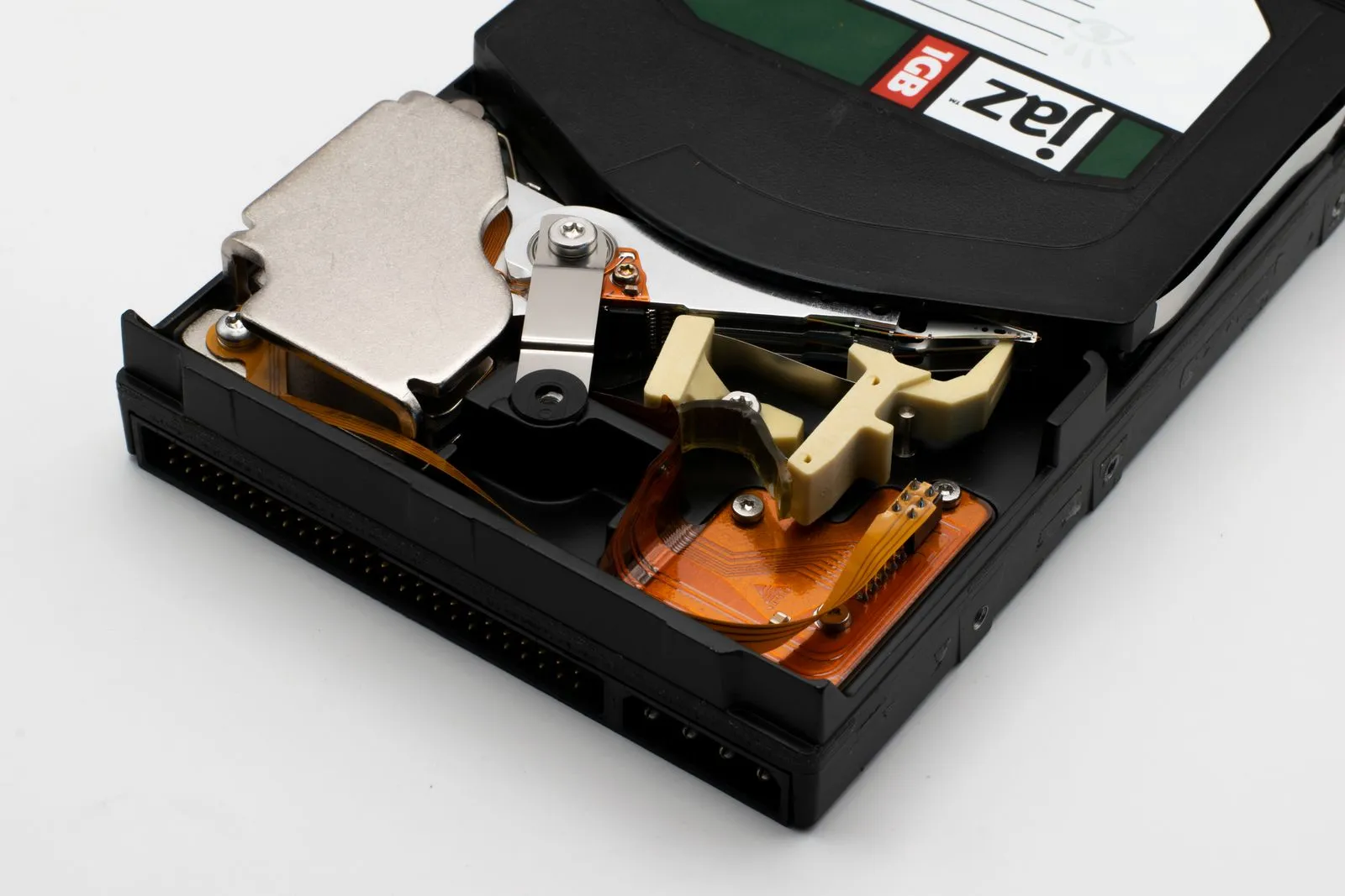Detailed close-up of an old hard drive showing internal mechanical parts and electronic circuits.
